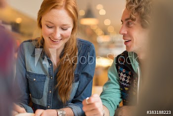 Smiling young couple in cafe