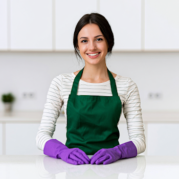 Smiling Young Woman in Modern Kitchen with Cleaning Gloves
