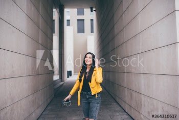 Smiling young woman listening to music outdoors