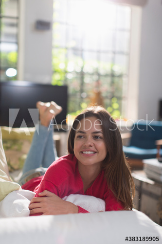 Smiling young woman relaxing on sofa