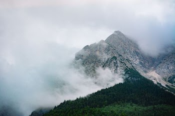 snow cap mountain surrounded by white clouds