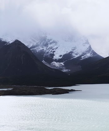 snow-capped mountain near body of water