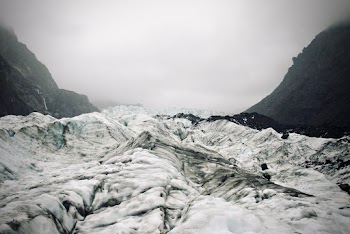 Snow Capped Mountain Under Cloudy Sky