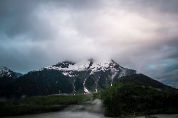 snow-capped mountain under gray sky
