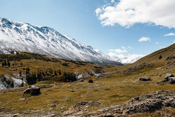 Snow Capped Mountains Under White Clouds