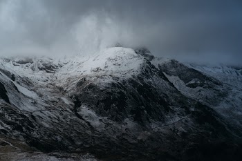 Snow-coned Mountain Under Cloudy Sky