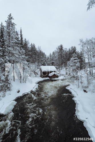 Snow-covered hut by  river in the Oulanka National Park, Finland