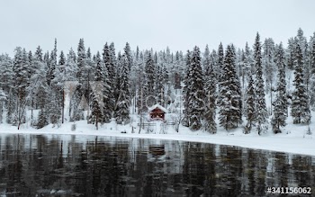 Snow-covered hut by  river in the Oulanka National Park, Finland