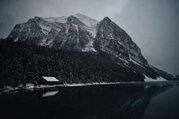 snow-covered mountain near body of water