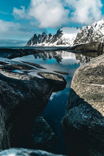 Snow-covered Mountain Near Body of Water