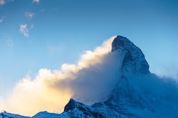 snow covered mountain under blue sky