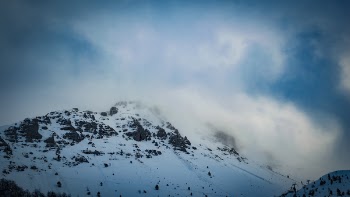 Snow Covered Mountain Under Cloudy Blue Sky