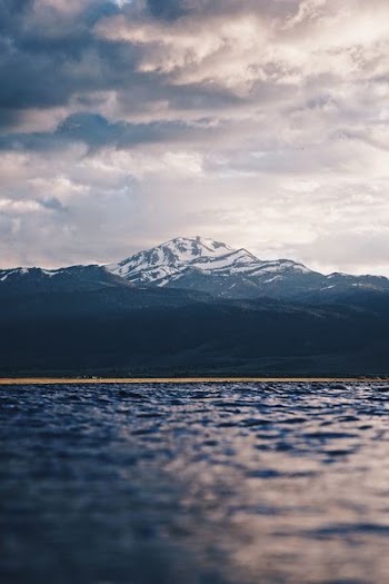 snow-covered mountain under cloudy sky