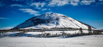 Snow-covered Mountain Under Cloudy Sky