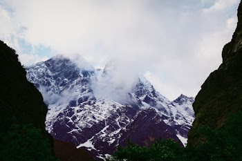 Snow Covered Mountain Under Cloudy Sky