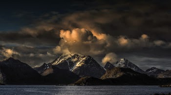 Snow Covered Mountain Under Cloudy Sky