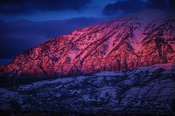 snow-covered mountain under cloudy sky during nighttime
