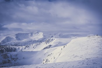 Snow Covered Mountain Under White Sky