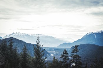snow covered mountain with sea of clouds