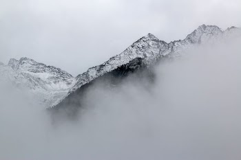 snow covered mountains near clouds