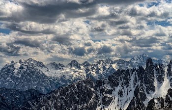 snow-covered mountains under cloudy sky