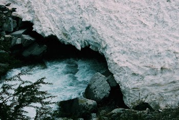 Snow Covered Rocks Near Stream