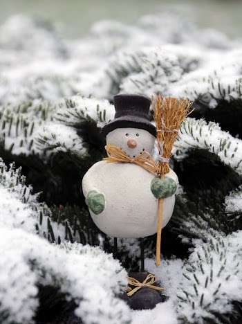 Snow Man Wearing Black Hat Holding Brown Broom