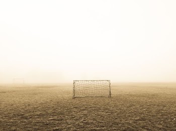 soccer goal on brown field