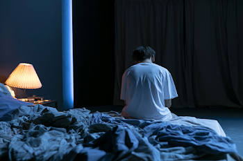 Solitary Reflection in a Dim Bedroom