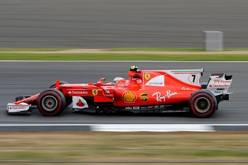 speeding formula-1 race car on race track during day