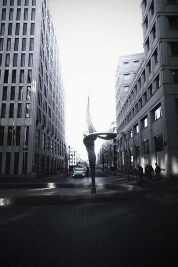 Spiral Shaped Fountain Statue Between Two High-rise Buildings