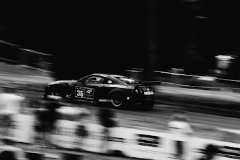 sports car in motion grayscale photography