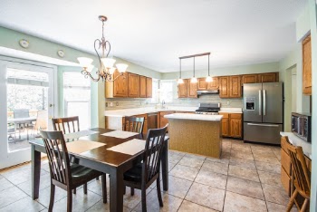 Square Brown Wooden Table Near Brown Modular Kitchen