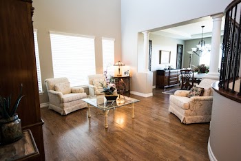 Square Clear Glass-top Center Table Near Gray Padded Armchair
