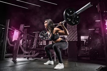 Squats with a barbell in the gym, the development of leg muscles, strengthening of the spine after injuries