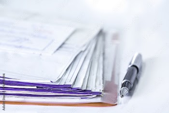 Stack of bills and pen