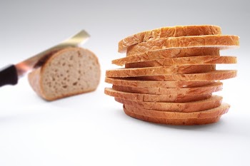 Stack of Wheat Sliced Bread on Top of White Surface