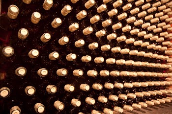 stacked up wine bottles in the cellar