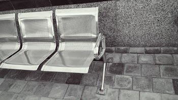 Stainless Steel Bench on Top of Gray Pavement