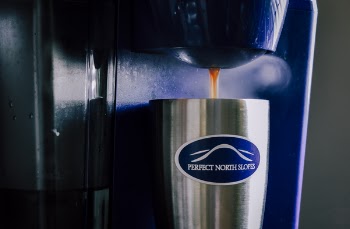 Stainless Steel Cup Filled With Coffee on Coffeemaker