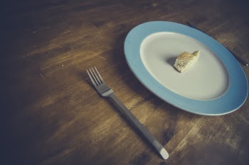 Stainless Steel Fork Near White and Blue Ceramic Pate With Brown Pastry