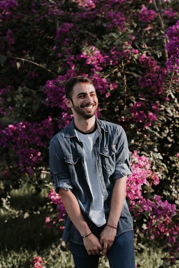 Standing Man Beside Pink Petaled Flower While Smiling