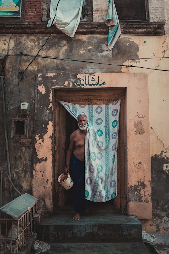 Standing Man Holding Plastic Pail Inside Building