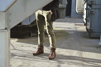 standing man with hand on pocket near machine