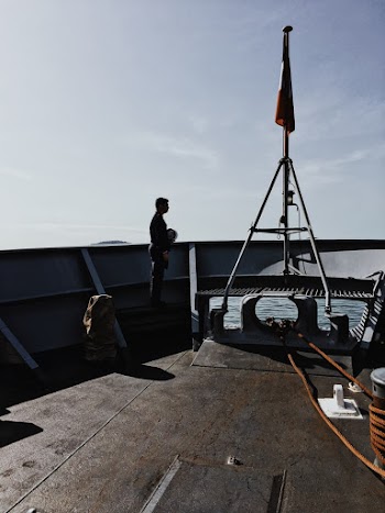Standing on the Edge of Boat