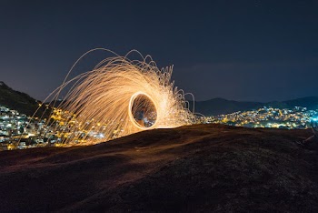 Standing Person Holding Light Sparks on Focus Photography