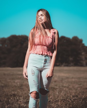Standing Person Wearing Pink Sleeveless Shirt and Blue Denim Jeans