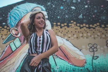 Standing Woman Front of Graffiti Wall