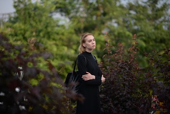 Standing Woman Holding Her Hands Beside Brown-leafed Plant