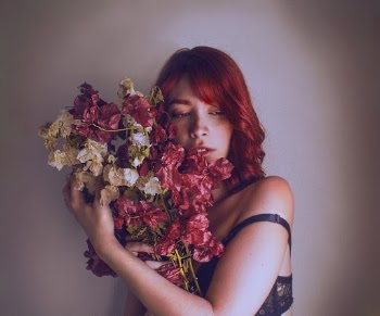 Standing Woman Holding White and Red Petaled Flowers